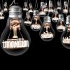Large group of light bulbs with shining fibers in a shape of INNOVATION and IDEA concept related words isolated on black background; horizontal composition